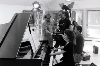 Pianist Catherine Wilson on location at Knollwood Place in Upper State NY for the video shoot of her composition entitled ‘Knollwood Place’. Lead camera man Bongo Kolycius is at back.  This was shot by NY City videographer Peter Rosen and is one of five videos that is part of a Series entitled Classical Vignettes. These videos are heard frequently on Classic Arts Showcase, PBS and numerous networks and platforms world-wide. 